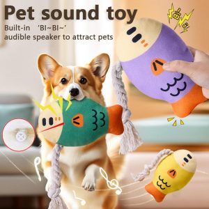 Dog playing with fish shaped plush rope squeaky toy