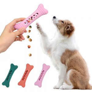 Dog playing with bone shaped chew toy