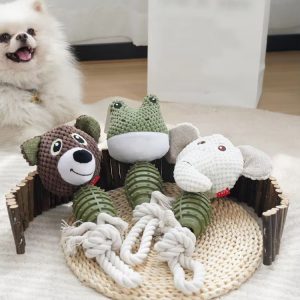 Dog playing with plush animal rope chew toy